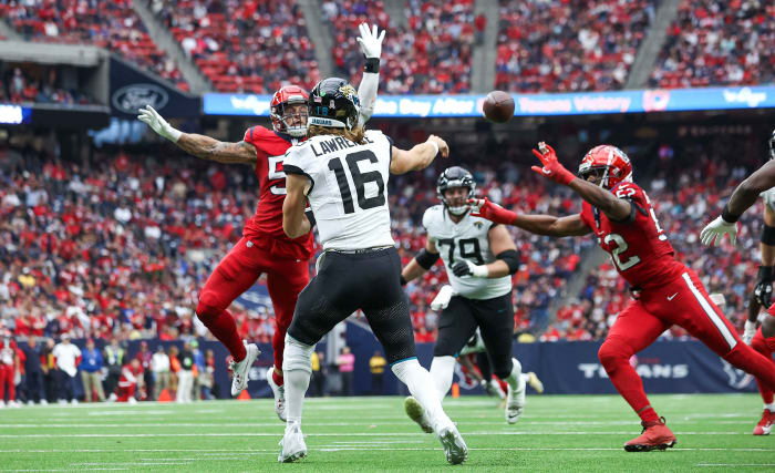 Jaguars quarterback Trevor Lawrence (16) attempts a pass as Houston Texans linebacker Blake Cashman (53) during the third quarter at NRG Stadium.